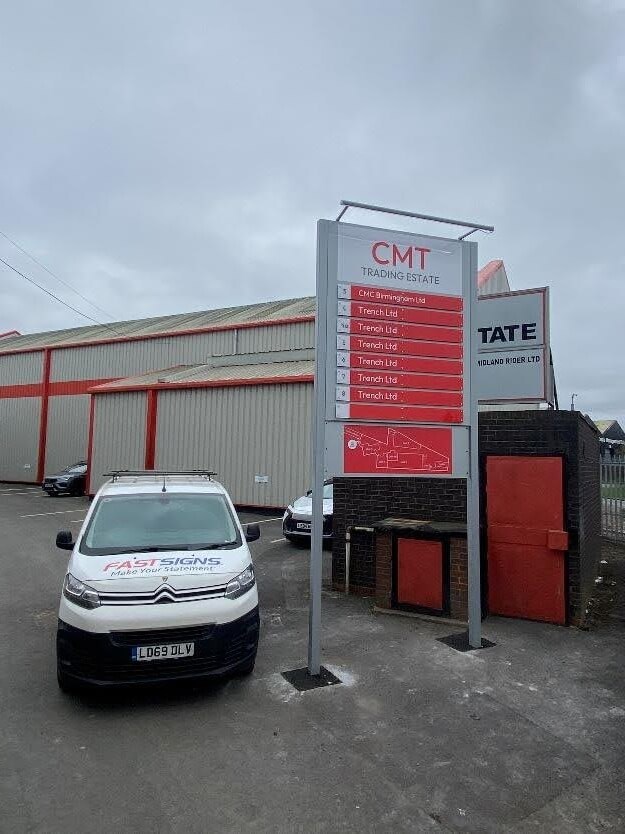 An image of a FASTSIGNS van next to the CMT totem sign.